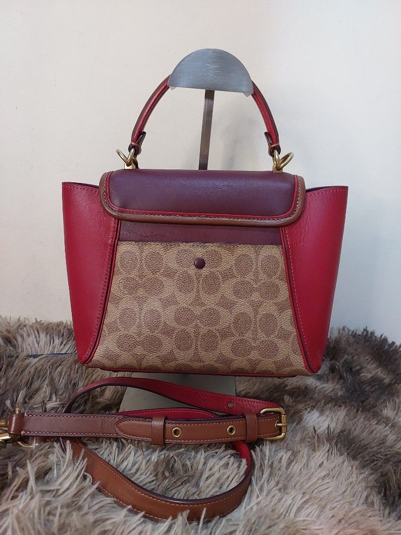 Coach Tabby Cherry Bag (Category: Luxury Bags & Wallets) located in Malabon City. Submitted by jullie_bag_shop (Listing ID 1439282544, Image 2). Description: - Coach Tabby bag with a charming cherry charm. - Features a detachable strap for versatile wear. - Signature pattern on the front. - Burgundy leather flap and base. - Gold-toned feet. - Top handle and secure zipper closure. - Interior includes a leather tag with Coach logo and serial number