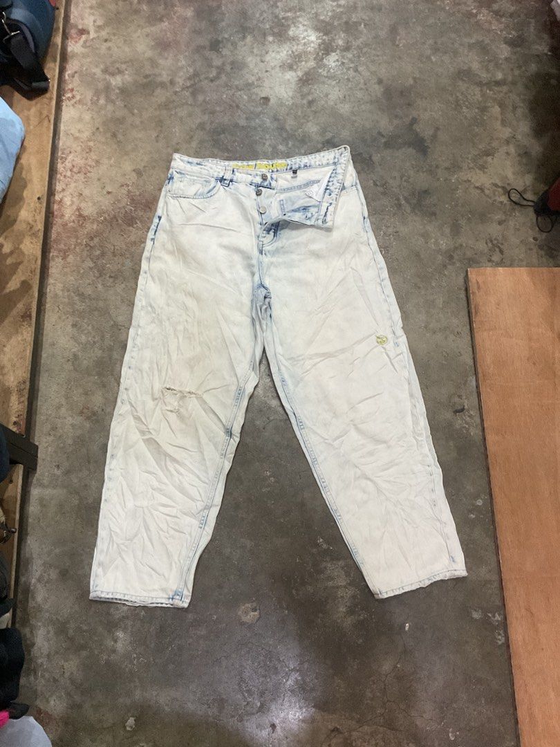 Drew House Acid Wash Jeans (Category: Jeans) located in Manila. Submitted by teampuyat224792 (Listing ID 1439376631, Image 2). Description: - Drew House acid wash jeans - Light blue wash - Relaxed fit - Smiley face logo on back pocket - Drew House branding on waistband - Button fly closure - Minor tear on front - waistline 34 - thigh 13.5 - length 39.5 - hem 8 .