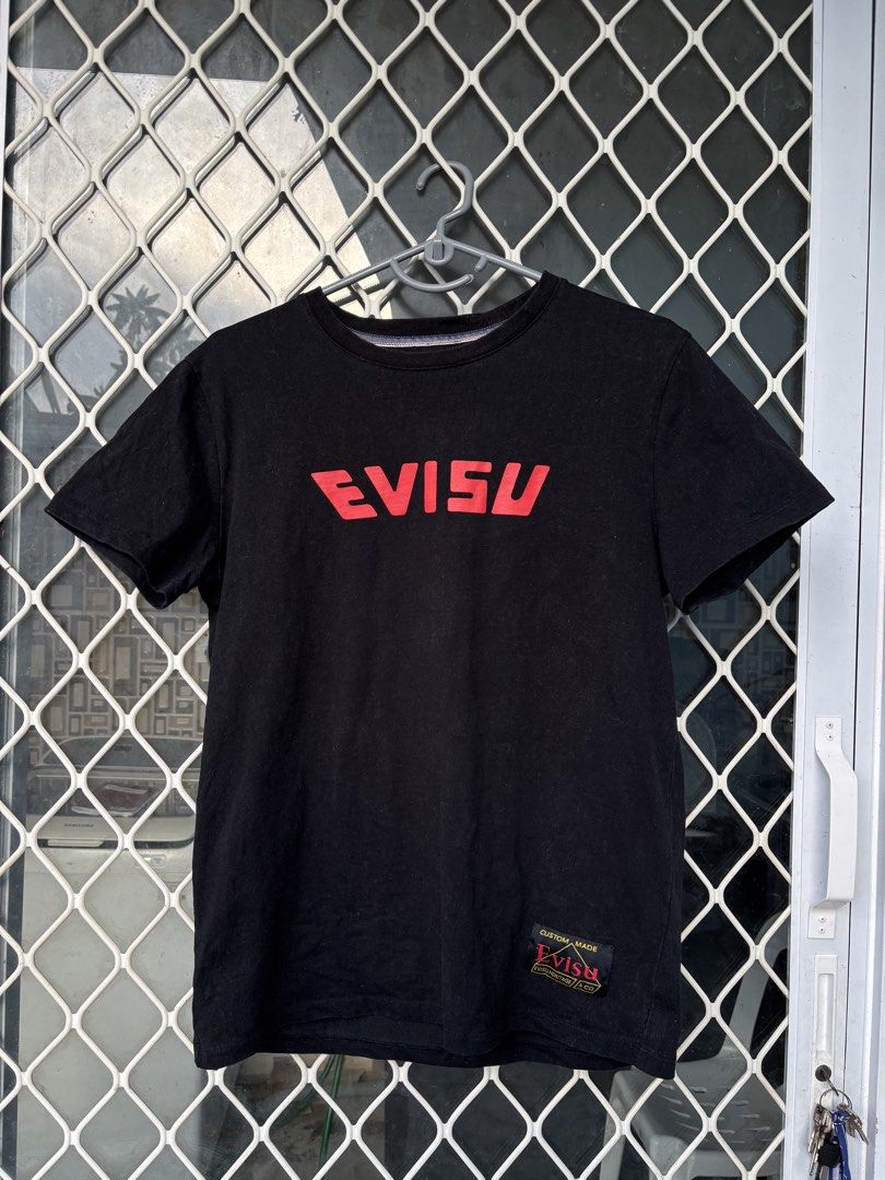 Evisu Graphic T-Shirt XL (Category: Tshirts & Polo Shirts ) located in Manila. Submitted by alexander_finds (Listing ID 1439311876, Image 1). Description: - Black Evisu t-shirt - Red logo on front - Graphic design on back with "Heritage" and "1991" - Size: XL - Includes custom Evisu tag.