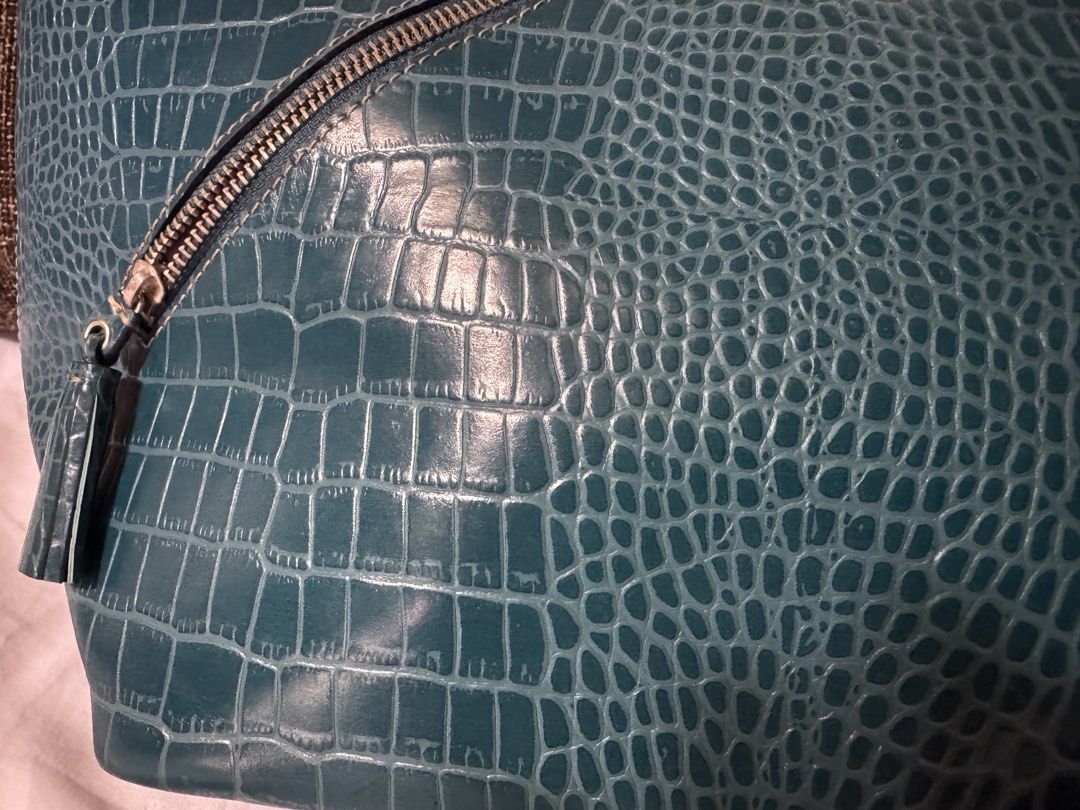 Fino Leatherware bag Teal Crocodile-Embossed Handbag (Category: Luxury Bags & Wallets) located in Manila. Submitted by jhayzel09 (Listing ID 1439274956, Image 2). Description: - Stylish teal handbag - Crocodile-embossed pattern - Top handle - Diagonal zipper detail with tassel accent - Rectangular shape with wider base - Glossy material bought at fino store robinsons magnolia no hidden issues lifetime warranty at all fino stores message me anytim