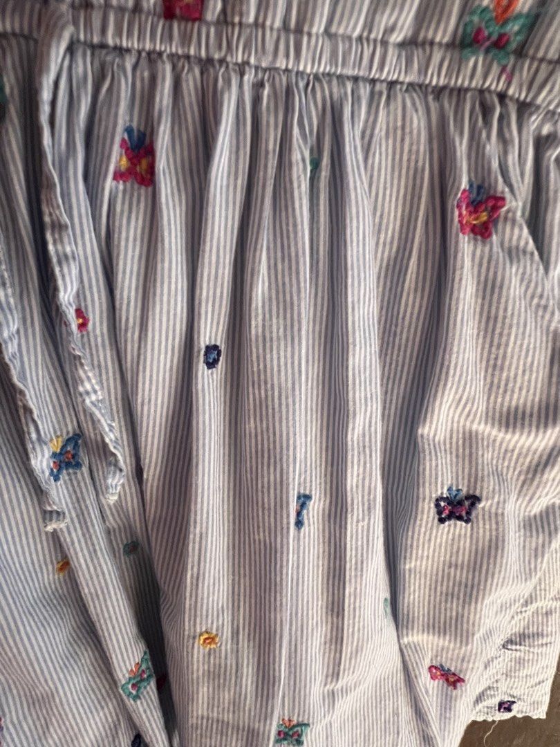 GAP Butterfly Embroidered Dress (Category: Babies & Kids Fashion) located in Bulacan. Submitted by nickxee (Listing ID 1439419969, Image 2). Description: - GAP dress 6-7 on Tag - Blue and white striped pattern - Butterfly embroidery - V-neck - Short sleeves - Elastic waist with drawstring - Pockets - Casual and comfortable.