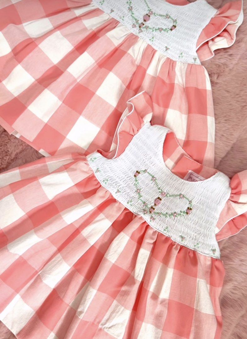 Gingham Smocked Dress 0-6M (Category: Babies & Kids Fashion) located in Pasig City. Submitted by summermid (Listing ID 1439256389, Image 1). Description: - Pink and white gingham dress - Hand smocked bodice with floral embroidery - Flutter sleeves - Lightweight fabric - Perfect for warm weather - Locally made.