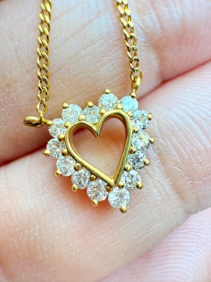 Gold Heart Pendant Necklace (Category: Necklaces) located in San Pedro. Submitted by loveeofgoldiss (Listing ID 1439381753, Image 1). Description: - Gold necklace with heart-shaped pendant - Pendant embellished with clear, sparkling stones - Delicate gold curb chain - Clasp marked "K18".