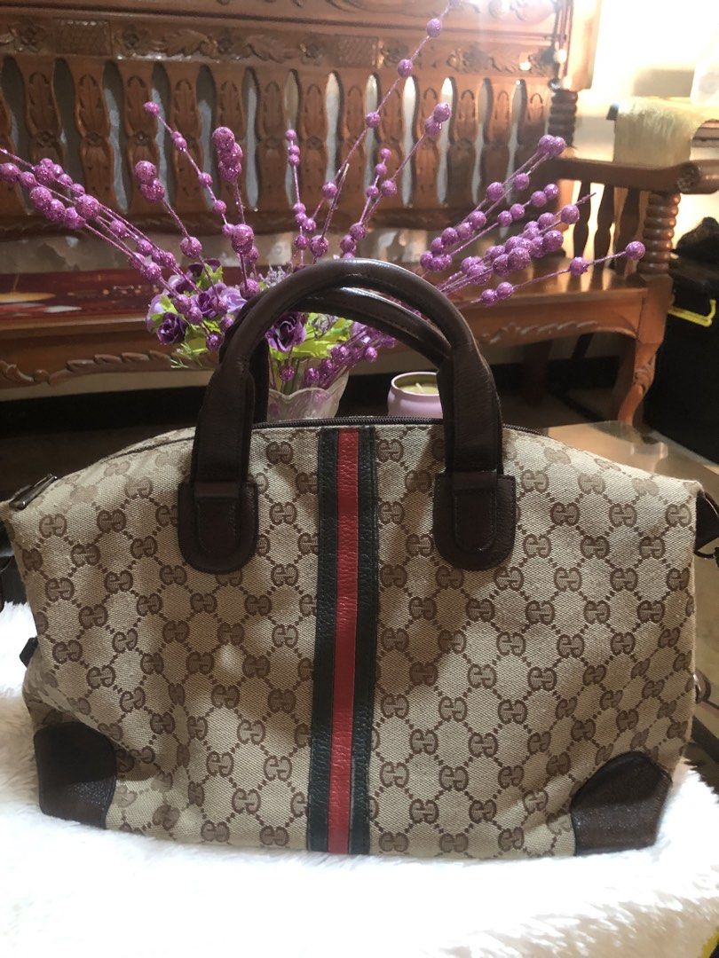 Gucci GG Canvas Handbag (Category: Luxury Bags & Wallets) located in Meycauayan. Submitted by miletteaqu82717 (Listing ID 1439302352, Image 2). Description: - not guaranteed Gucci handbag - Iconic GG canvas - Brown leather handle and trim - Signature red and green stripe - Zip closure - Medium size.
