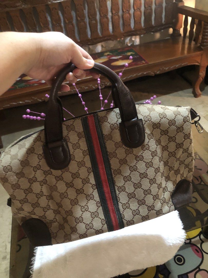 Gucci GG Canvas Handbag (Category: Luxury Bags & Wallets) located in Meycauayan. Submitted by miletteaqu82717 (Listing ID 1439302352, Image 3). Description: - not guaranteed Gucci handbag - Iconic GG canvas - Brown leather handle and trim - Signature red and green stripe - Zip closure - Medium size.