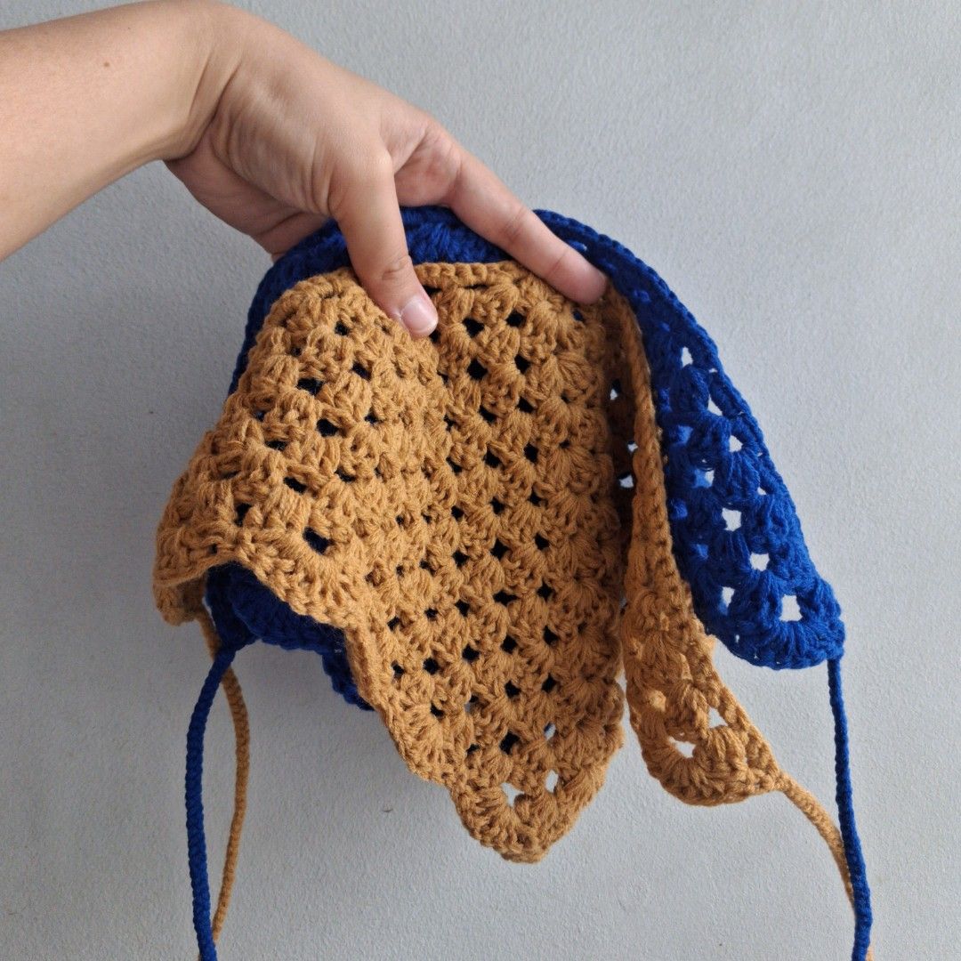 Handmade Crochet Bandana (Category: Purses & Pouches) located in Cebu City. Submitted by starlinggg (Listing ID 1439355624, Image 1). Description: - Handmade crochet handbag - Unique blue and brown color combination - Distinctive shape - Includes straps for carrying - Stylish accessory for everyday use.