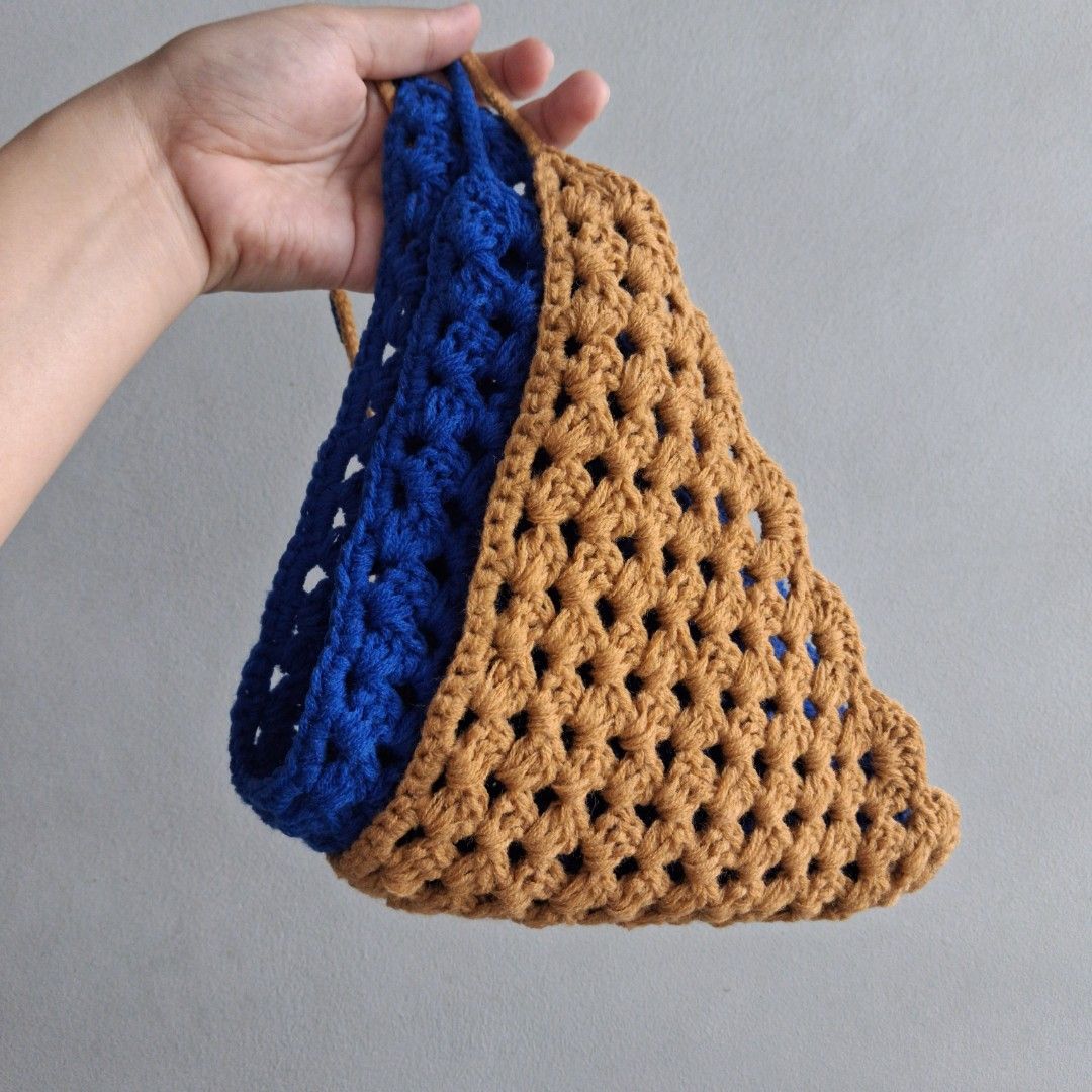Handmade Crochet Bandana (Category: Purses & Pouches) located in Cebu City. Submitted by starlinggg (Listing ID 1439355624, Image 2). Description: - Handmade crochet handbag - Unique blue and brown color combination - Distinctive shape - Includes straps for carrying - Stylish accessory for everyday use.