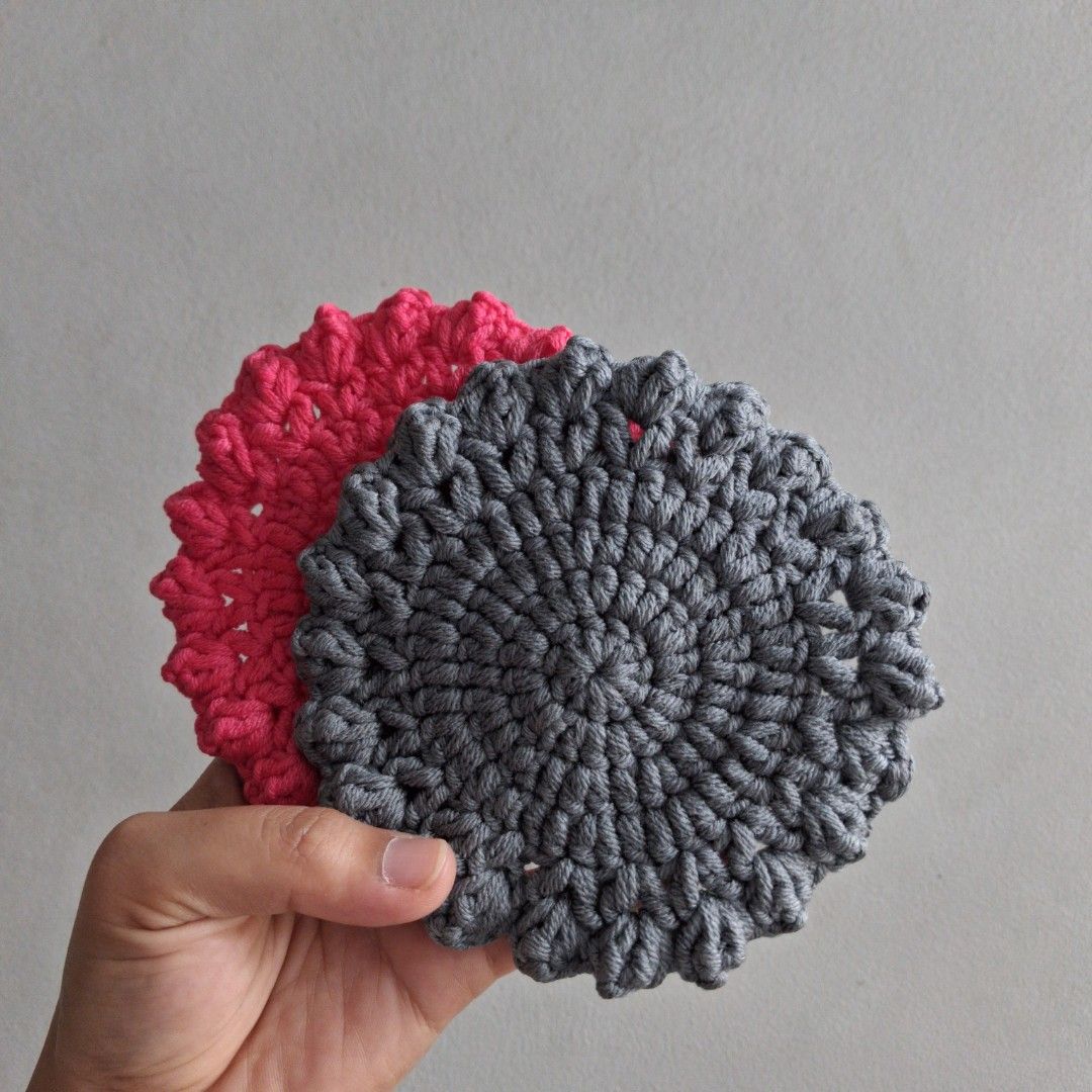 Handmade Crochet Coasters - Set of 2 (Category: Handmade Craft) located in Cebu City. Submitted by starlinggg (Listing ID 1439355745, Image 2). Description: - Set includes two handmade crochet coasters - Colors: Gray and Pink - Shape: Round - Design: Textured - Packaging: Each coaster individually packaged in a clear plastic bag - Includes a 'Thank You' message - Perfect for protecting surfaces - Adds a handmade touch to your home.