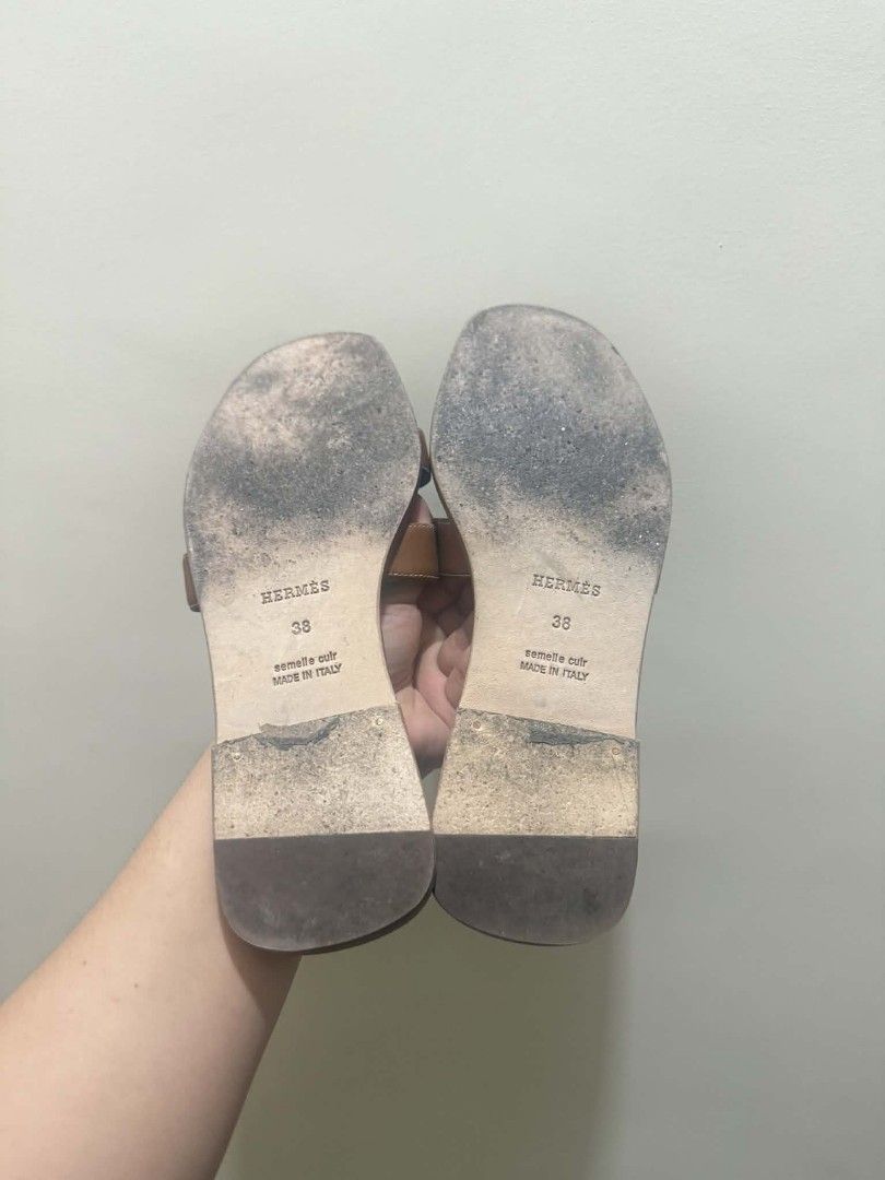 Hermes Oran Sandals - Brown - Size 38 (Category: Flats & Sandals) located in Manila. Submitted by newowl.293cb5 (Listing ID 1439282662, Image 3). Description: - Authentic Hermes Oran sandals - Color: Brown - Size: 38 - Iconic H cut-out design - Made in Italy - Condition: Good, with wear on soles - Perfect for everyday wear.