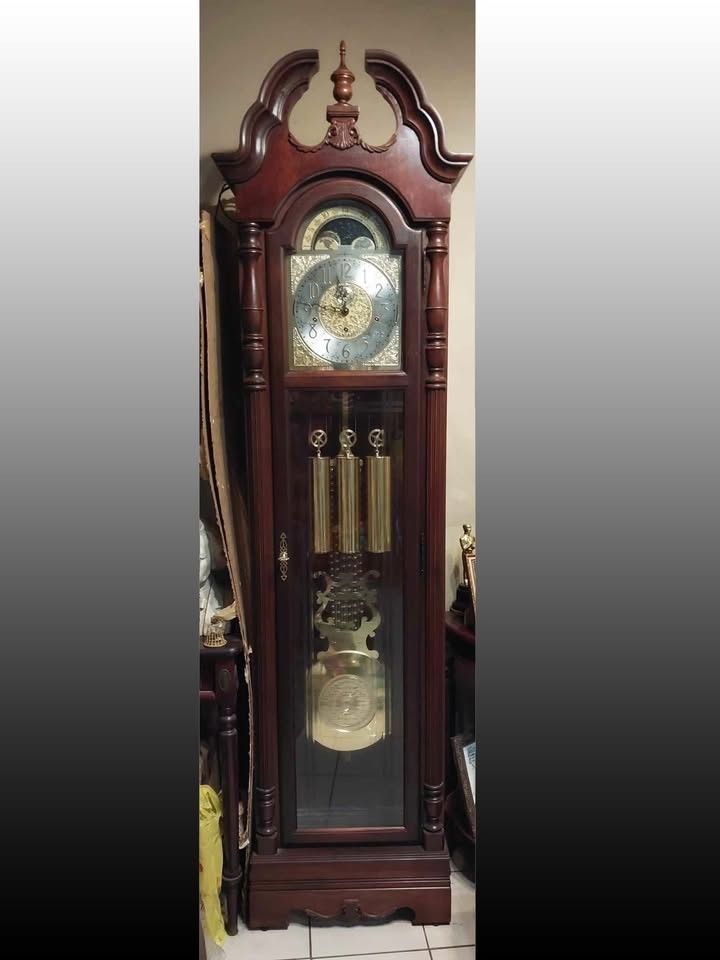 Howard Miller Grandfather Clock (Category: Clocks) located in Manila. Submitted by bryantoyshop (Listing ID 1439257435, Image 1). Description: Size: H.85-1/4 W.22 D.13-1/2 in. With its mechanical movement and wind-up power source, it is a perfect addition to any antique collection. The clock features a wooden frame, glass front, and an oak finish. Original Howard Miller Cabinet is illuminated by an interior light (110V). .