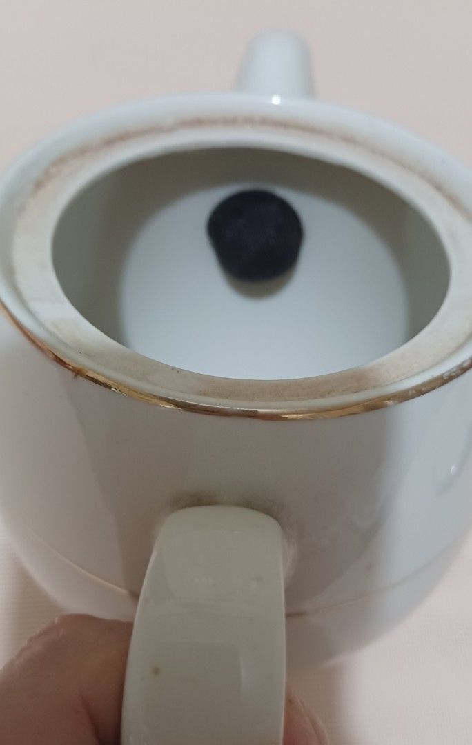 Hoya Ivory China Teapot (Category: Coffee & Tea Tableware) located in Quezon City. Submitted by wjmae (Listing ID 1439274399, Image 3). Description: - White teapot with lid. - Features silver trim on lid and band around the body. - Brand: "Hoya Ivory China". - Made in Japan. - Includes handle and spout..