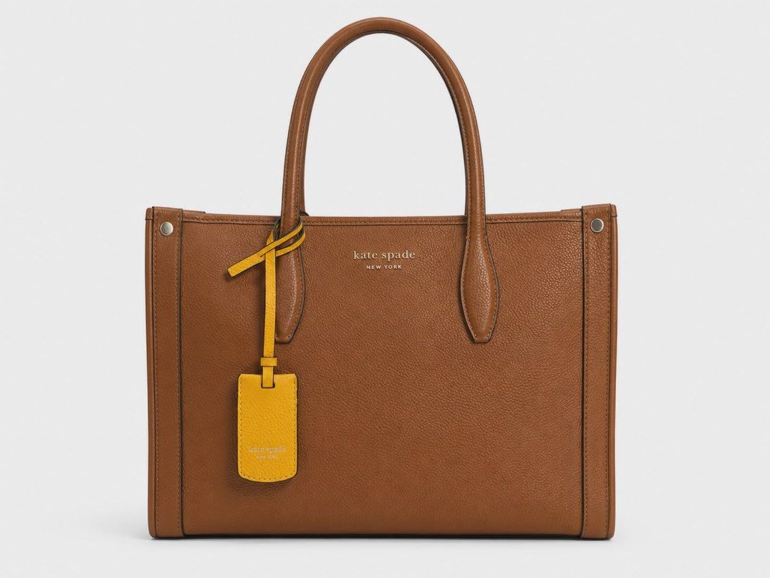 Kate Spade Brown Leather Tote Bag (Category: Tote Bags) located in Cainta. Submitted by rey0325 (Listing ID 1439355089, Image 1). Description: - Kate Spade brown leather tote bag - Rectangular shape - Top handles - Detachable yellow tag - Simple design - Kate Spade logo on the front - Made of textured leather.