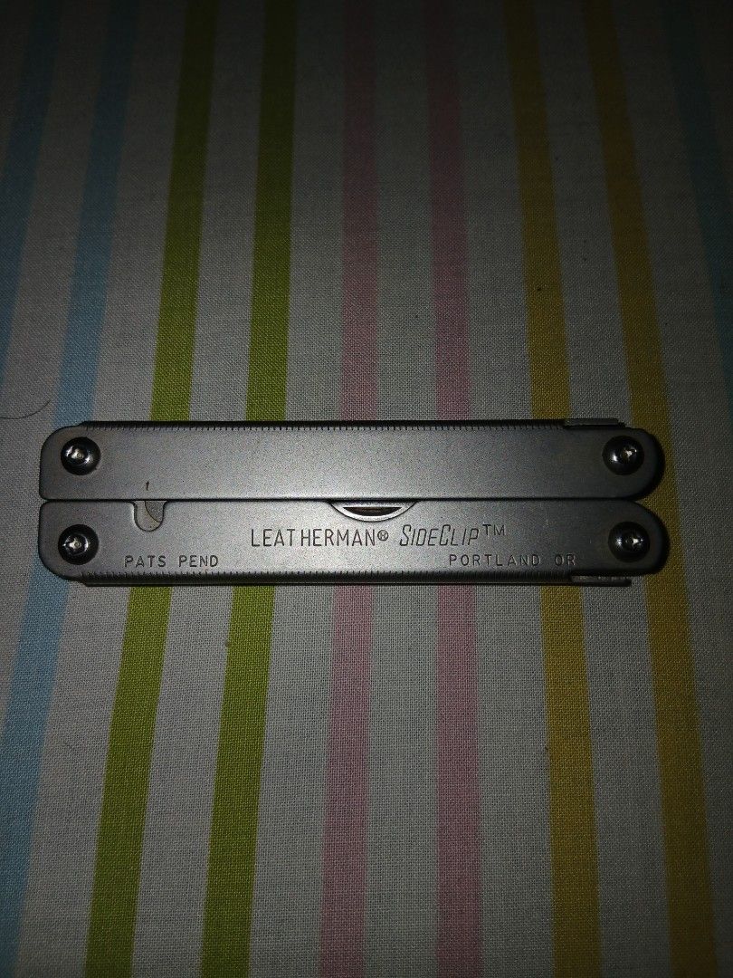 Leatherman Sideclip Multi-tool (Category: Home Improvement Tools & Accessories) located in Caloocan City. Submitted by wwonderleyy (Listing ID 1439291433, Image 2). Description: - Leatherman Sideclip multi-tool - Features pliers, knife, and more - Compact and portable design - Marked with "LEATHERMAN SIDECLIP" - Includes "PORTLAND, OR" marking.