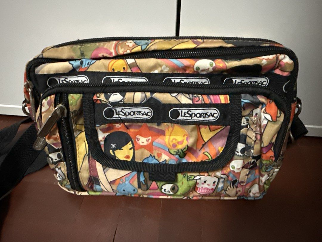 LeSportsac Crossbody Bag (Category: Cross-body Bags) located in Manila. Submitted by matet_s (Listing ID 1439388204, Image 1). Description: - LeSportsac crossbody bag - Colorful print - Multiple compartments - Adjustable black strap - LeSportsac logo on front.