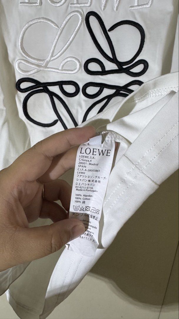 Loewe Embroidered Logo T-shirt (Category: Tshirts & Polo Shirts ) located in Quezon City. Submitted by mogsmogs (Listing ID 1439391678, Image 3). Description: - Loewe white t-shirt - Embroidered logo on front - Made in Portugal - 100% cotton - Crew neck - Short sleeves Dimes: 22 width x 27 length Rfs: nakatambak sa closet, tumaba ako.