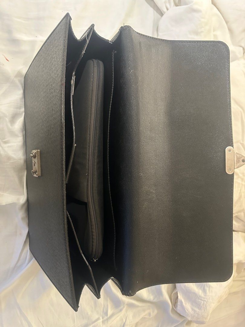 Louis Vuitton Briefcase for Men (Category: Luxury Bags & Wallets) located in Makati City. Submitted by eastgold_ph (Listing ID 1439266375, Image 2). Description: - Original Louis Vuitton briefcase - Secure lock closure - Top handle for easy carrying - Interior with multiple compartments, including a padded laptop section - Textured black exterior - Silver-toned hardware - Made in France Original price is P130,000.