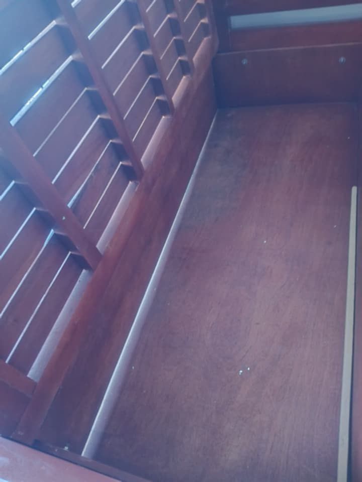 Mahogany Wooden Bed Frame with Storage (Category: Bed Frames & Mattresses) located in Makati City. Submitted by sheeca (Listing ID 1439335931, Image 3). Description: - Solid wood bed frame - Dark, rich finish - Decorative headboard design - Built-in storage with two doors - Slatted base for mattress support - Spacious storage compartments - there is a bit of discolouration on the storage compartment area - note pure mahogany wood - heavy duty bed