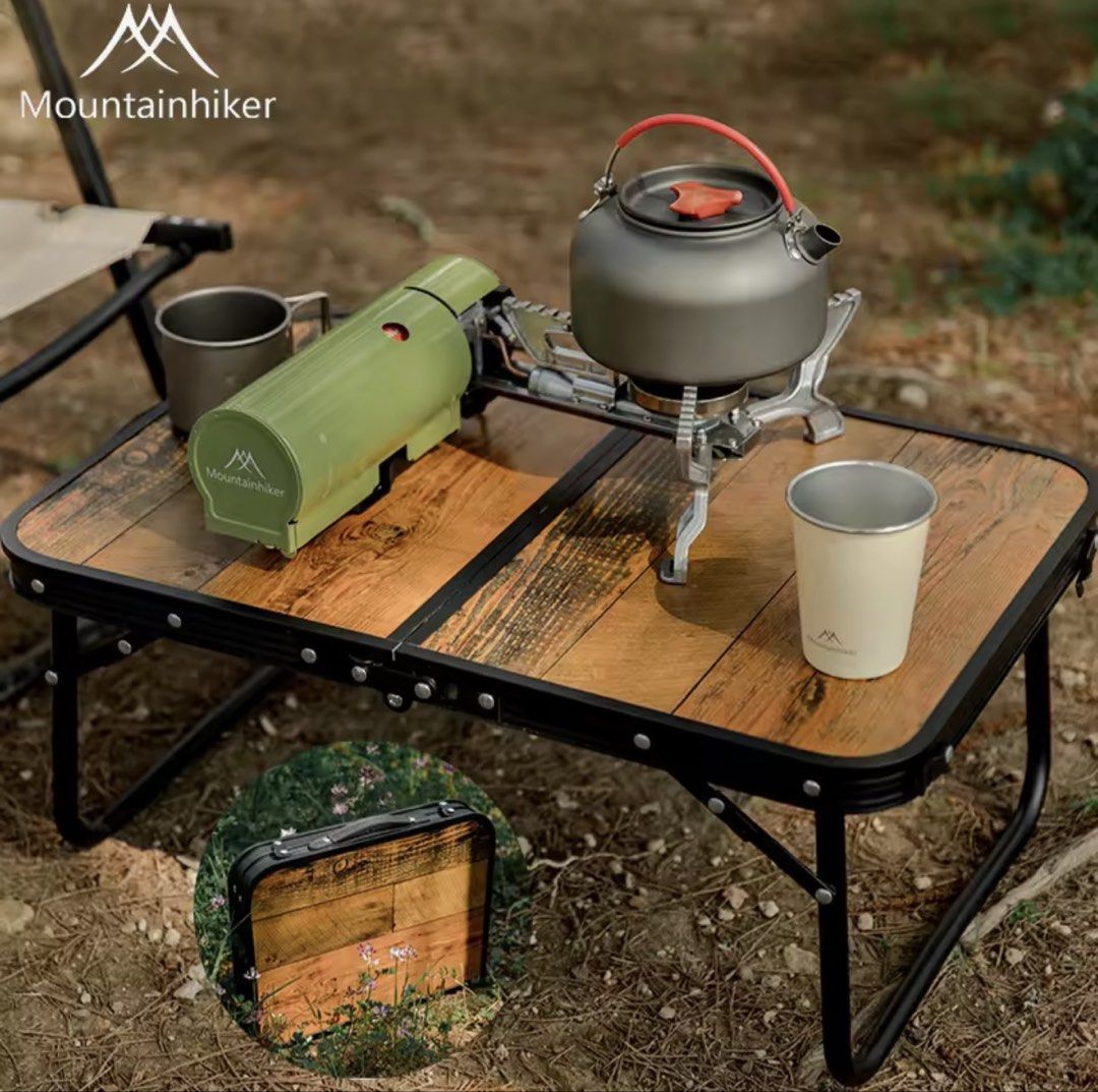 MOUNTAINHIKER Folding Wooden Table (Category: Tables & Sets) located in Quezon City. Submitted by immarxc (Listing ID 1439350971, Image 2). Description: - Mountainhiker folding table for outdoor activities. - Features a durable wooden tabletop. - Comfortable rubber handle for carrying. - Sturdy support base made of aluminum alloy. - Strong and rust-resistant stainless steel frame. - Folds up compactly for easy storage and transport. - Ideal for c