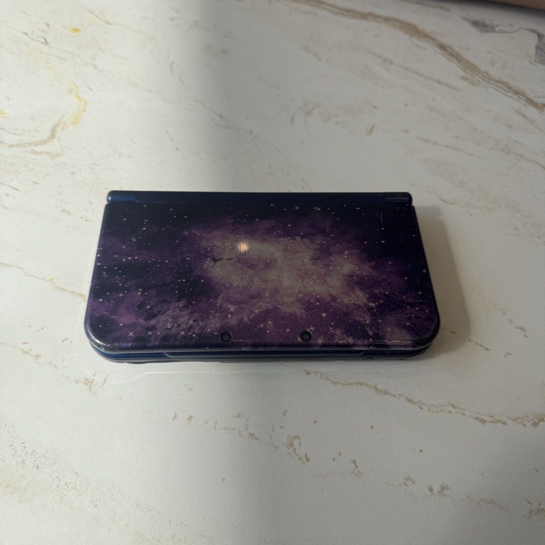 New Nintendo 3DS XL Galaxy Edition (Category: Nintendo) located in Pili. Submitted by potanginasagabi (Listing ID 1439310624, Image 1). Description: - Nintendo 3DS Galaxy Edition - Galaxy-themed top cover design - Blue console body - Standard buttons and controls - Minor signs of wear and tear on the top cover Flaws: no stylus, doesnt turn on, scratch and burn marks, missing screw - i dont know if gumagana yung joystick or buttons since kaka kuha