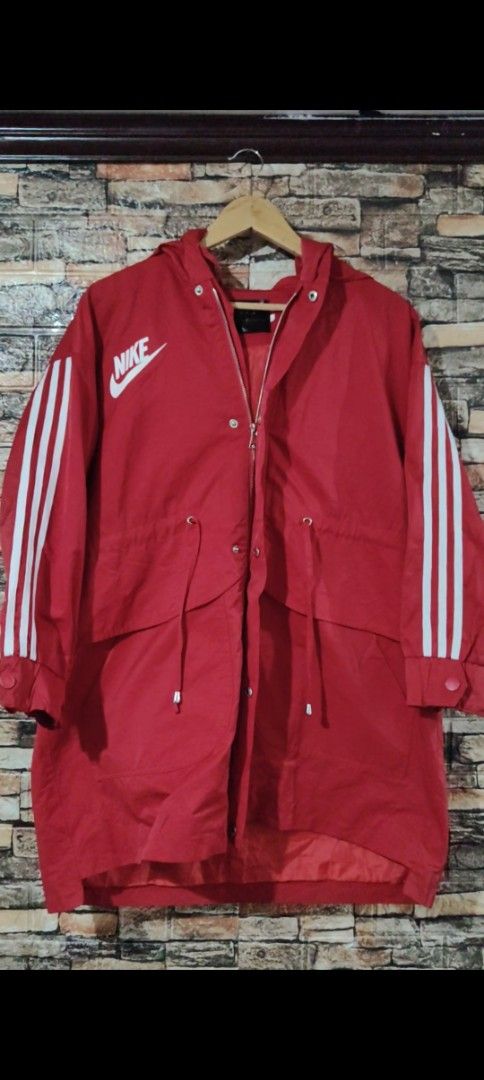 Nike Adidas Red Jacket (Category: Coats, Jackets and Outerwear) located in Manila. Submitted by adrian2325 (Listing ID 1439412245, Image 1). Description: - Red jacket - Nike logo on front and back - Adidas stripes on sleeves - Hooded - Zipper closure - Drawstrings at waist - Longer style.