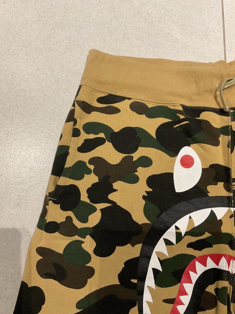 Original BAPE Shark Shorts (Category: Shorts) located in Quezon City. Submitted by aguilartam12610 (Listing ID 1439349200, Image 2). Description: Original BAPE Shark Shorts in yellow camo. Size XL. Features the iconic shark face design, drawstring waist, and back pocket..