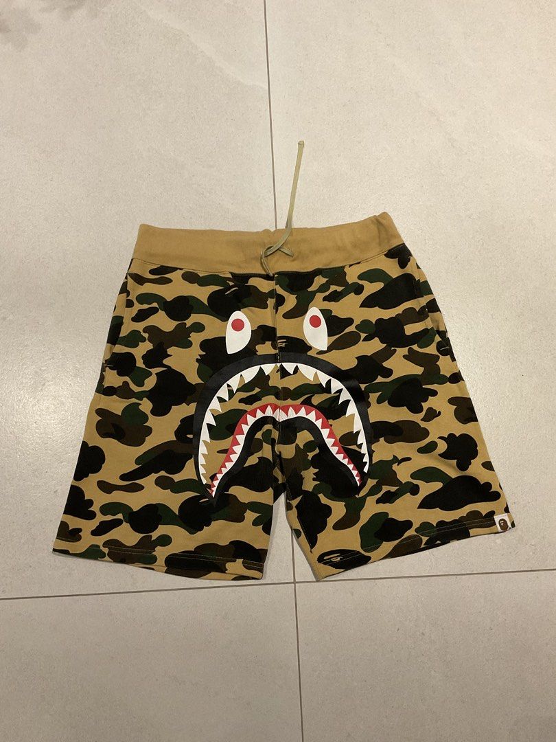 Original BAPE Shark Shorts (Category: Shorts) located in Quezon City. Submitted by aguilartam12610 (Listing ID 1439349200, Image 1). Description: Original BAPE Shark Shorts in yellow camo. Size XL. Features the iconic shark face design, drawstring waist, and back pocket..