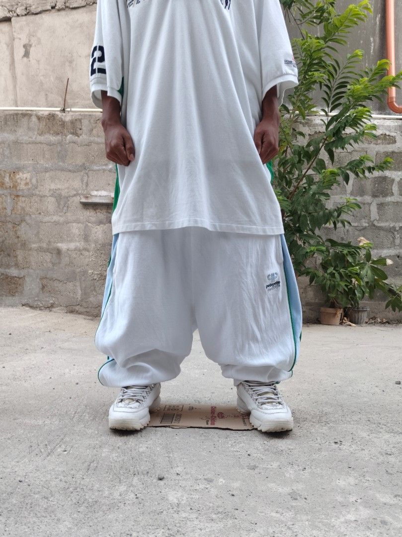 Pelle Pelle Velour Pants (Category: Jeans) located in Tuguegarao City. Submitted by xiraaaaa (Listing ID 1427749588, Image 1). Description: White velour pants from Pelle Pelle. Features blue and green stripes on the sides. Has an elastic waistband and a small logo on the leg. Made of 70% cotton and 30% polyester. issue: minimal yellow stain washable nmn dm na!!.