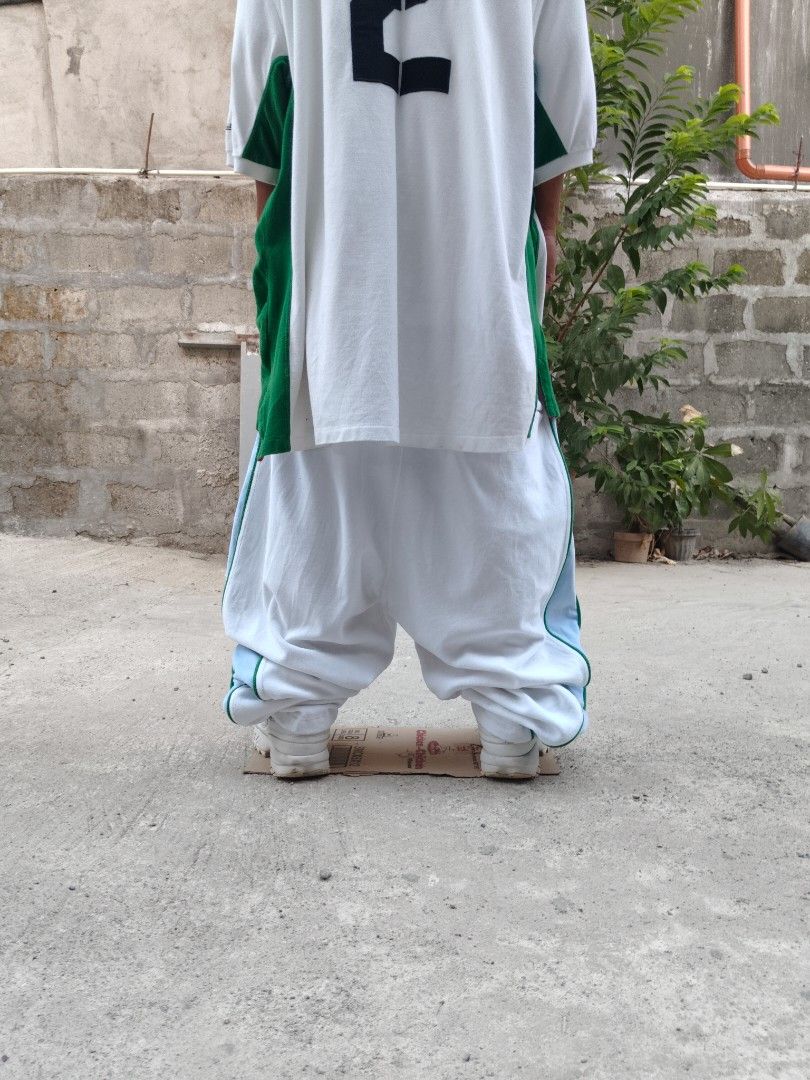 Pelle Pelle Velour Pants (Category: Jeans) located in Tuguegarao City. Submitted by xiraaaaa (Listing ID 1427749588, Image 2). Description: White velour pants from Pelle Pelle. Features blue and green stripes on the sides. Has an elastic waistband and a small logo on the leg. Made of 70% cotton and 30% polyester. issue: minimal yellow stain washable nmn dm na!!.