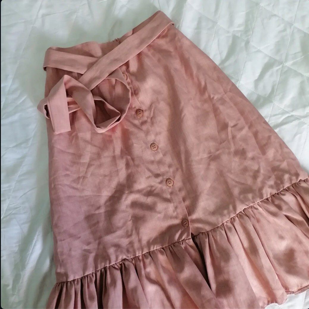 Pink Midi Skirt with Ruffle Hem (Category: Skirts) located in Itogon. Submitted by m_xary (Listing ID 1439351963, Image 1). Description: - Soft pink midi skirt - Flattering A-line shape - Ruffle hem - Matching belt included - Button details - Versatile for casual and semi-formal wear 🎀sf must be shouldered by the buyer 🎀MOP: Gcash.