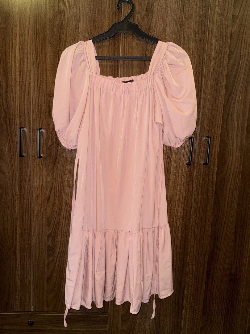 Pink Puff Sleeve Dress (Category: Dresses) located in Manila. Submitted by hiraya2025 (Listing ID 1439261580, Image 1). Description: - Square neckline - Puff sleeves - Flowy skirt with ruffled hem - Side tie details - Light pink color - Smooth fabric.