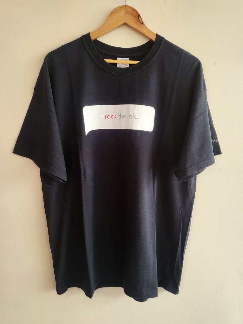 Playstation 2 Singstar T-shirt (Category: Tshirts & Polo Shirts ) located in Bulacan. Submitted by waybak90s (Listing ID 1439318460, Image 1). Description: - PlayStation 2 promotional t-shirt - Features "I rock the mic" and "Singstar Rocks!" graphics - Includes a "Playstation.2" logo on the sleeve - Classic round neck design - Short sleeves - Likely made of cotton.