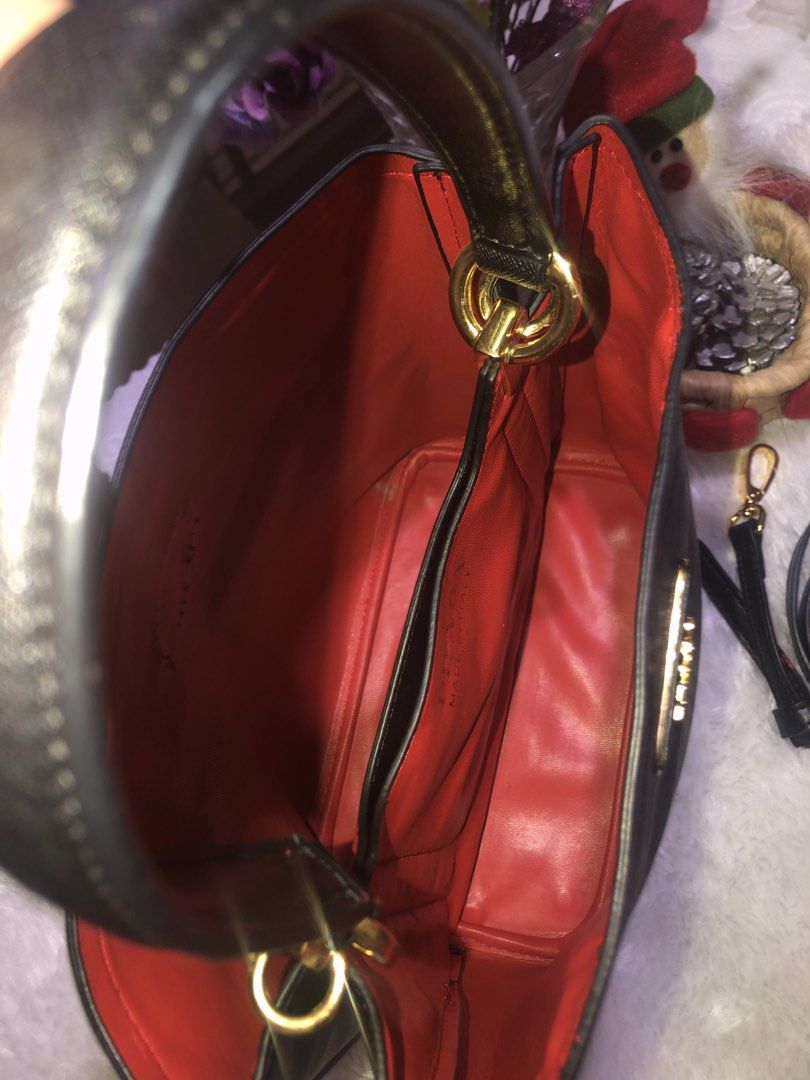 Prada Black Handbag with Red Interior (Category: Luxury Bags & Wallets) located in Meycauayan. Submitted by miletteaqu82717 (Listing ID 1439305000, Image 3). Description: - not guaranteed Prada handbag - Classic black exterior - Striking red interior - Gold Prada logo and hardware - Detachable black strap - Structured shape with top handles - Interior pocket with Prada label - no lock major flaw.