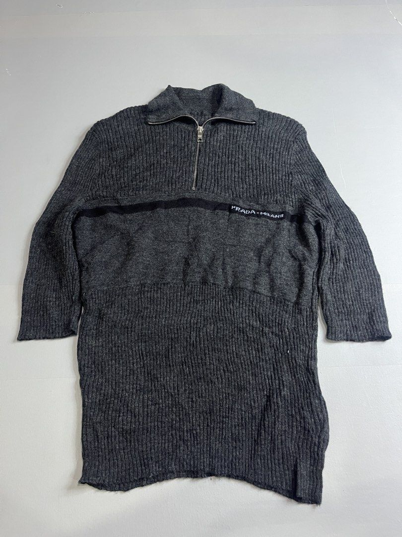 Prada Jeans Wool Sweater (Category: Luxury Apparel) located in Mabalacat. Submitted by aas_thriftfings (Listing ID 1439341466, Image 1). Description: - Prada Jeans sweater - Dark gray color - Half-zip closure - Prada-Milano logo on chest - 100% wool - Ribbed knit design - Made in Italy.