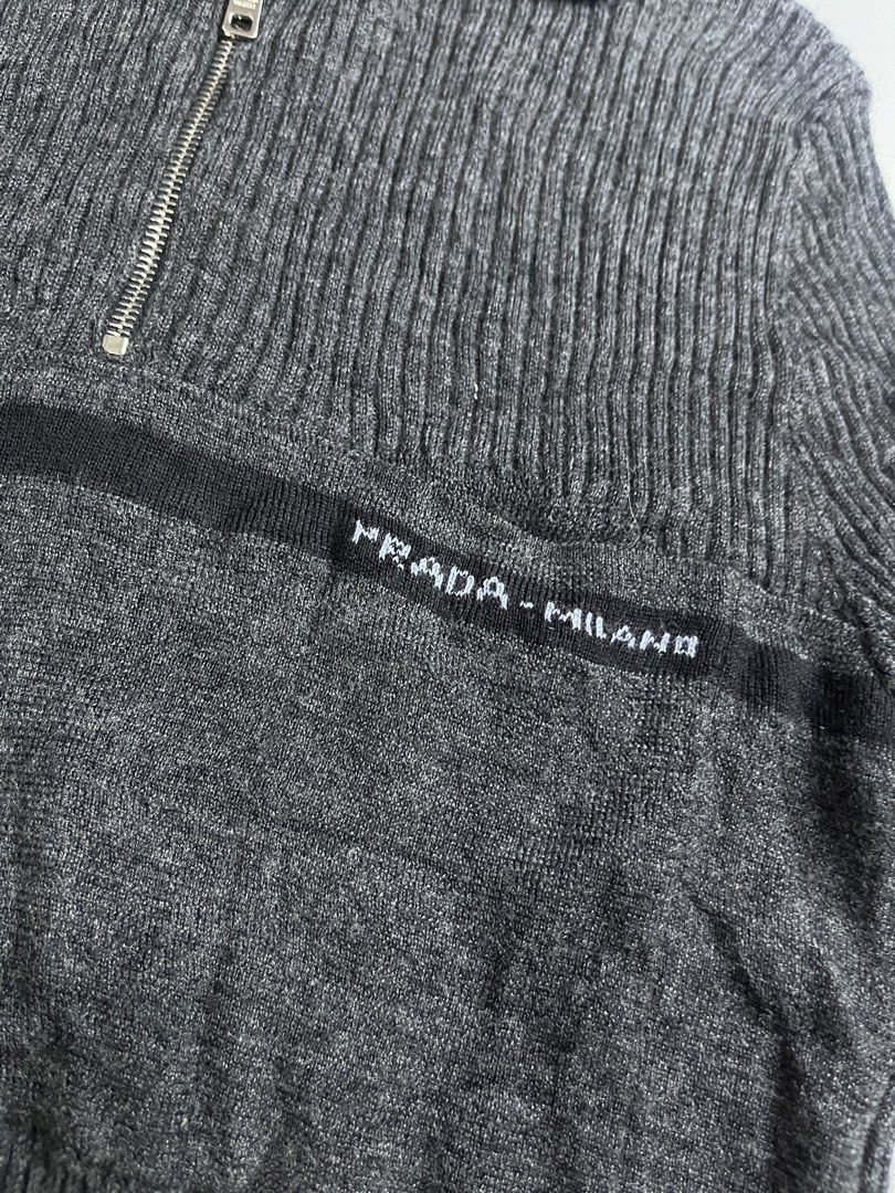Prada Jeans Wool Sweater (Category: Luxury Apparel) located in Mabalacat. Submitted by aas_thriftfings (Listing ID 1439341466, Image 2). Description: - Prada Jeans sweater - Dark gray color - Half-zip closure - Prada-Milano logo on chest - 100% wool - Ribbed knit design - Made in Italy.