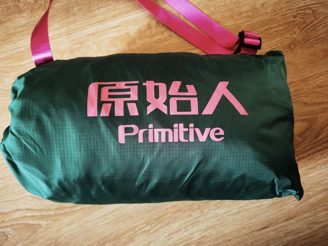 Primitive Sleeping Bag - Green (Category: Hiking & Camping) located in Singapore. Submitted by m.ava (Listing ID 1439391313, Image 1). Description: - Primitive sleeping bag - Suitable for camping and travel - Comes with a carrying bag - Bag color: Green with pink lettering - Condition: Lightly used.