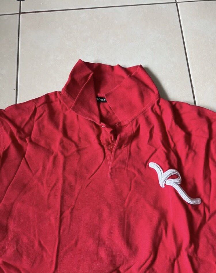 roca wear (Category: Tshirts & Polo Shirts ) located in Manila. Submitted by bitchessss (Listing ID 1439292695, Image 2). Description: - Red polo shirt - White logo on chest - Collared neckline - Short sleeves - Soft fabric - Classic polo design - Buttoned placket - Suitable for casual wear.