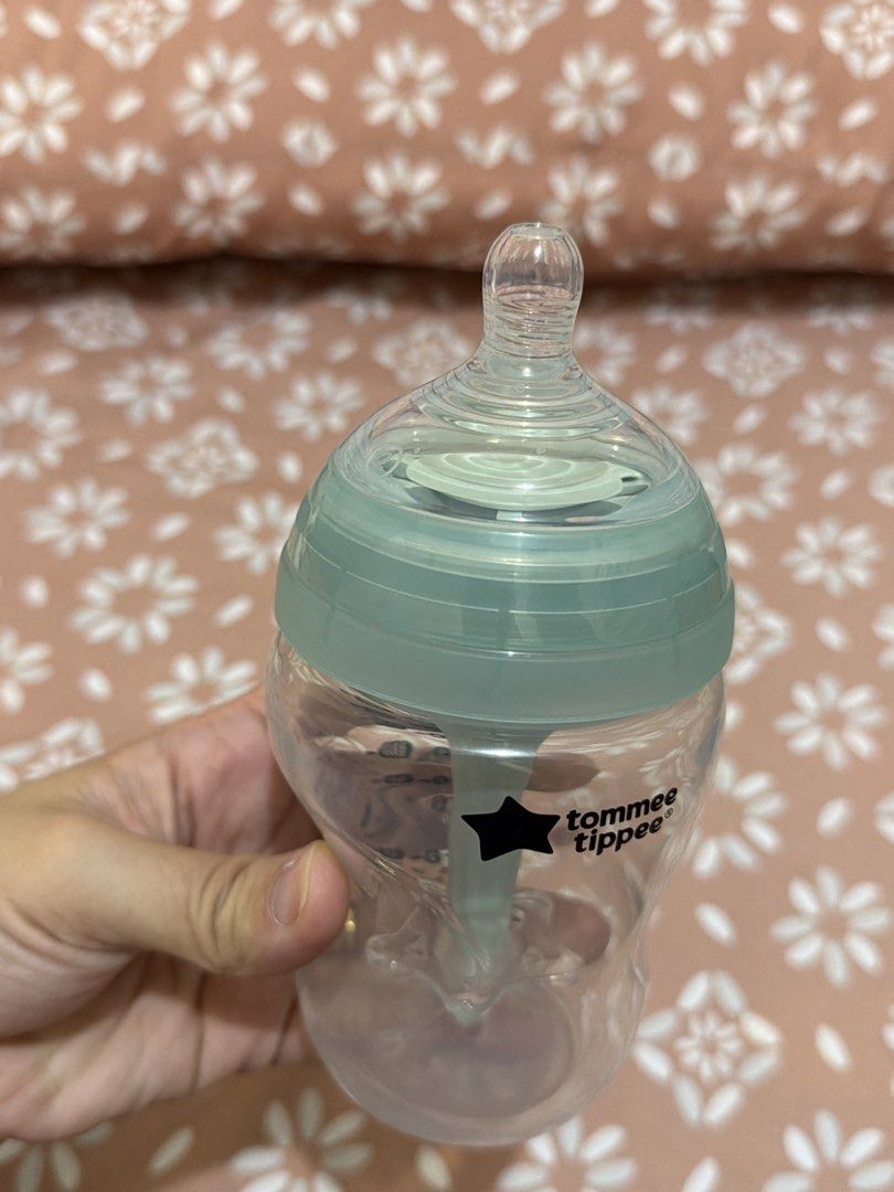 Tommee Tippee Baby Bottle (Category: Breastfeeding & Bottle Feeding) located in San Simon. Submitted by classystyles (Listing ID 1439408780, Image 2). Description: Tommee Tippee baby bottle. Features a clear bottle with a green-tinted lid and nipple. The bottle has measurement markings in both US fl oz and ml. The bottle has a unique shape for easy handling. Perfect for feeding your little one. Tried it but my baby don’t want the nipple :((.