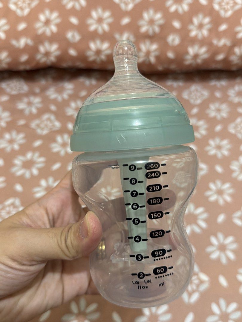 Tommee Tippee Baby Bottle (Category: Breastfeeding & Bottle Feeding) located in San Simon. Submitted by classystyles (Listing ID 1439408780, Image 3). Description: Tommee Tippee baby bottle. Features a clear bottle with a green-tinted lid and nipple. The bottle has measurement markings in both US fl oz and ml. The bottle has a unique shape for easy handling. Perfect for feeding your little one. Tried it but my baby don’t want the nipple :((.