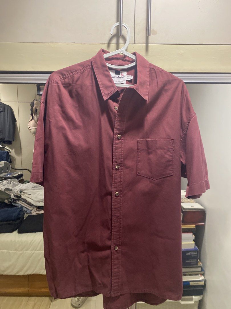 Topman Short Sleeve Shirt - Maroon (Category: Tshirts & Polo Shirts ) located in Manila. Submitted by pre.luved.items (Listing ID 1439322057, Image 1). Description: Topman maroon short sleeve shirt, size Large. Features a chest pocket and button-down closure. Made in India..
