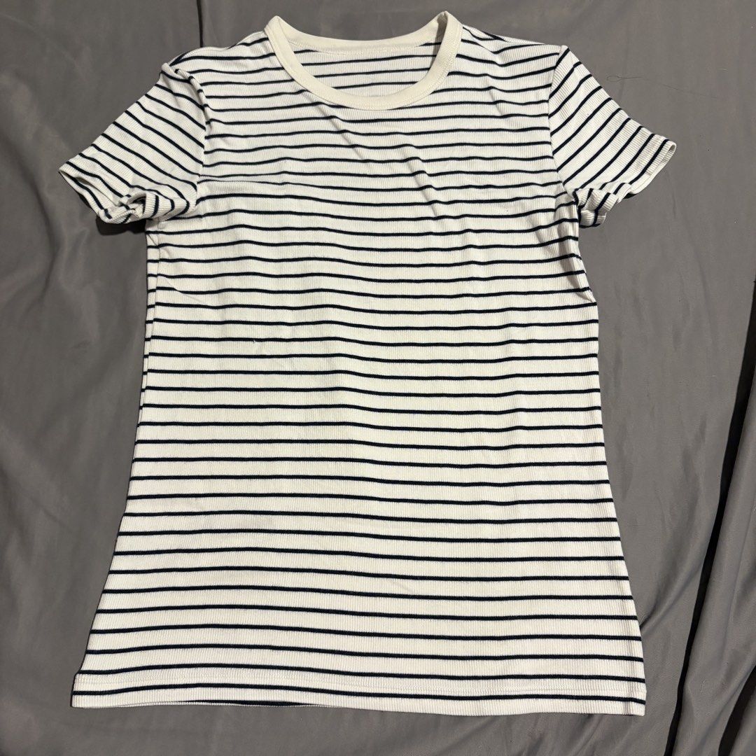 Uniqlo Striped T-shirt - Medium (Category: Shirts) located in Manila. Submitted by icy_________ (Listing ID 1439289497, Image 1). Description: - Uniqlo striped t-shirt - Size: Medium - Color: White with navy blue stripes - Fabric: Ribbed knit - Neckline: Round - Sleeves: Short - Material: Cotton, rayon, spandex.
