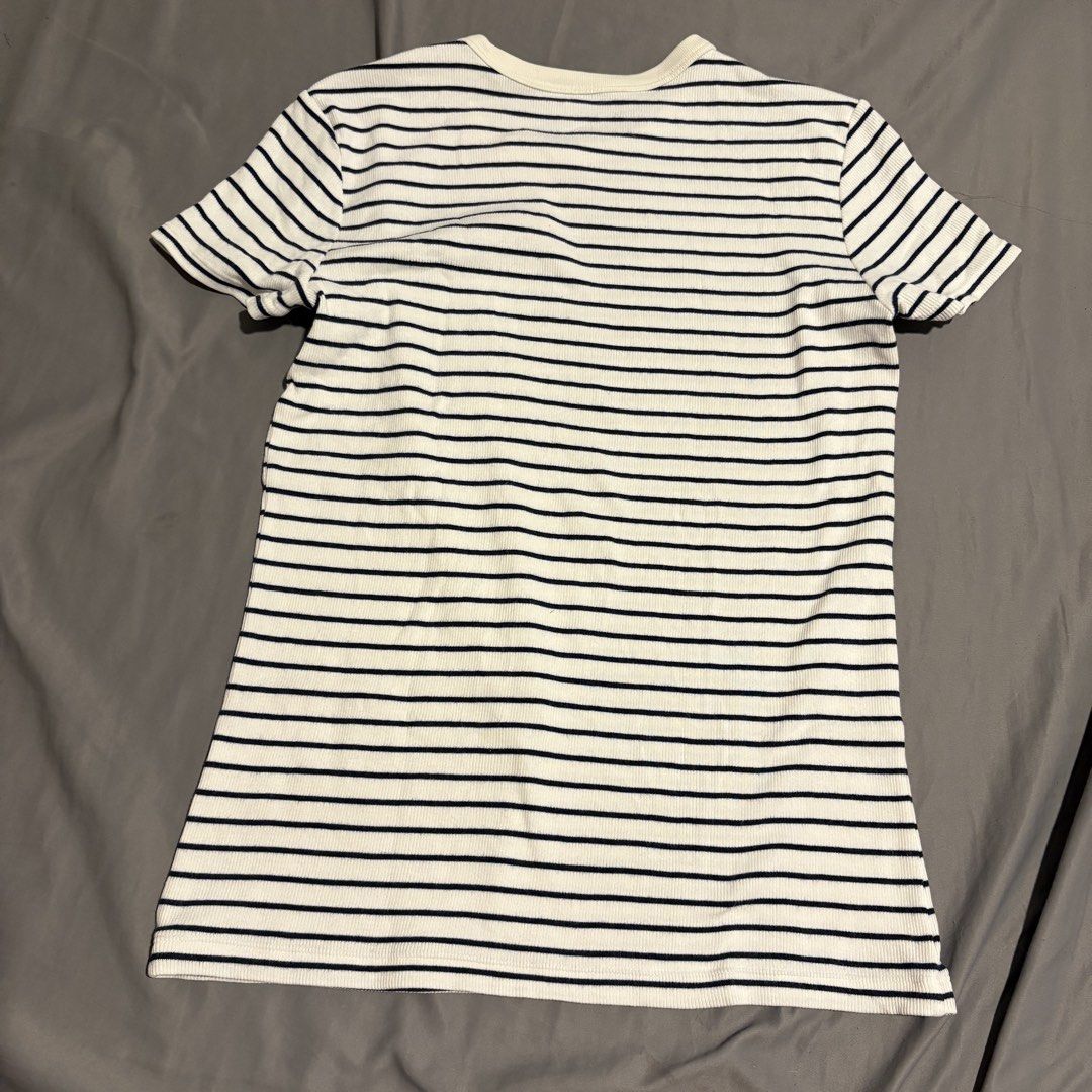 Uniqlo Striped T-shirt - Medium (Category: Shirts) located in Manila. Submitted by icy_________ (Listing ID 1439289497, Image 2). Description: - Uniqlo striped t-shirt - Size: Medium - Color: White with navy blue stripes - Fabric: Ribbed knit - Neckline: Round - Sleeves: Short - Material: Cotton, rayon, spandex.