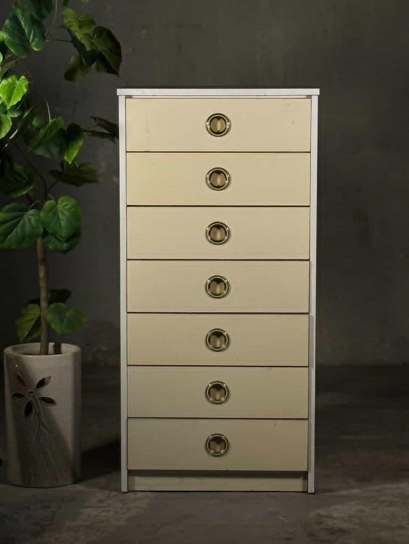 Vintage 7-Drawer Dresser (Category: Shelves, Cabinets & Racks) located in Valenzuela. Submitted by upcycle_things (Listing ID 1439368256, Image 2). Description: - Vintage dresser - Seven drawers for ample storage - Stylish brass-toned circular handles - Light cream-colored drawers - Neutral-toned frame - Tall and narrow design, ideal for smaller spaces - Made of wood.