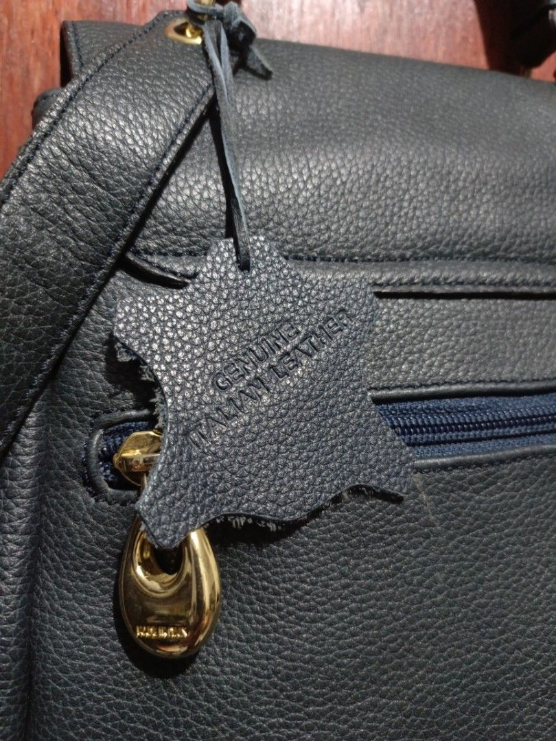 Vintage Genuine Italian Leather Backpack (Category: Backpacks) located in San Jose del Monte. Submitted by m_nshop (Listing ID 1439347112, Image 2). Description: - Genuine Italian leather backpack - Drawstring closure - Flap with decorative wooden squares - Patterned interior lining - Interior zippered pocket - Top handle - Adjustable shoulder straps - Gold-colored zipper and hardware - Includes "Genuine Italian Leather" tag PRELOVED NEEDS CLEANI