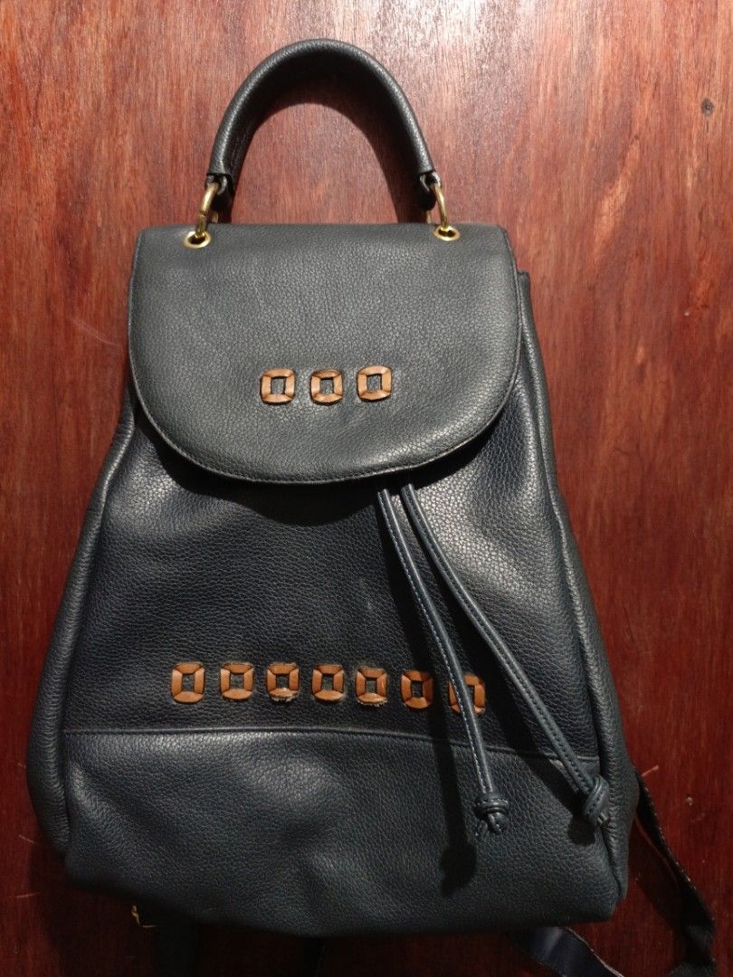 Vintage Genuine Italian Leather Backpack (Category: Backpacks) located in San Jose del Monte. Submitted by m_nshop (Listing ID 1439347112, Image 1). Description: - Genuine Italian leather backpack - Drawstring closure - Flap with decorative wooden squares - Patterned interior lining - Interior zippered pocket - Top handle - Adjustable shoulder straps - Gold-colored zipper and hardware - Includes "Genuine Italian Leather" tag PRELOVED NEEDS CLEANI