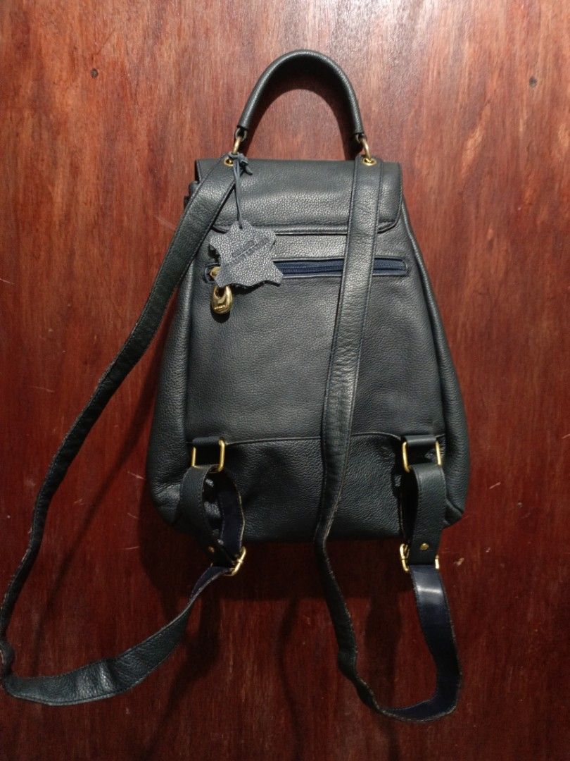 Vintage Genuine Italian Leather Backpack (Category: Backpacks) located in San Jose del Monte. Submitted by m_nshop (Listing ID 1439347112, Image 3). Description: - Genuine Italian leather backpack - Drawstring closure - Flap with decorative wooden squares - Patterned interior lining - Interior zippered pocket - Top handle - Adjustable shoulder straps - Gold-colored zipper and hardware - Includes "Genuine Italian Leather" tag PRELOVED NEEDS CLEANI