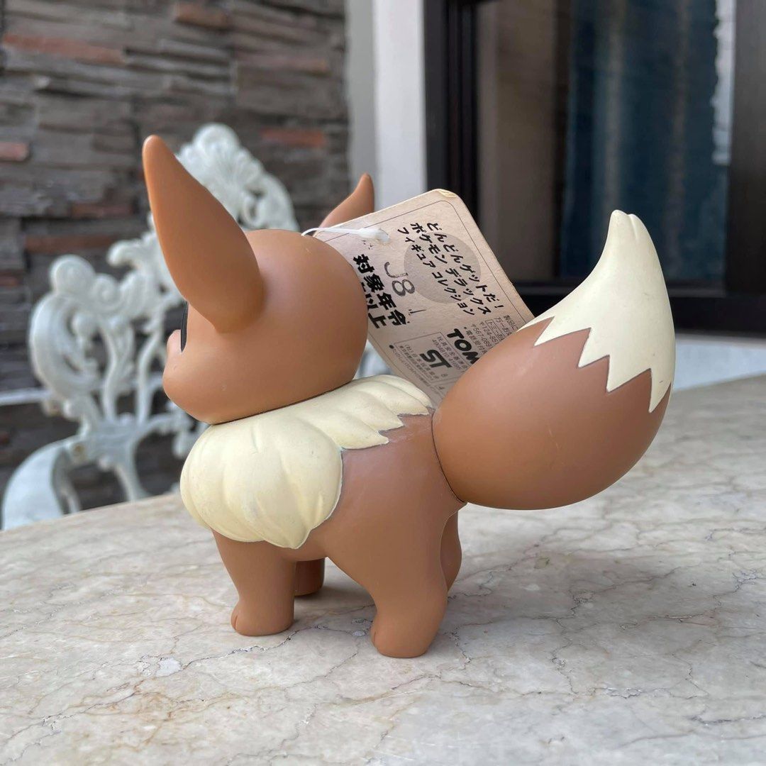 Vintage Tomy Pokemon Eevee Figure (Category: Figurines & Statues) located in Quezon City. Submitted by dangogow (Listing ID 1439346046, Image 3). Description: Tomy Pokemon Eevee figure. It has a brown body, cream-colored fur, and large ears. The figure comes with its original tag. The bottom of the figure has the year 1998 printed on it. It is a collectible item for Pokemon fans..