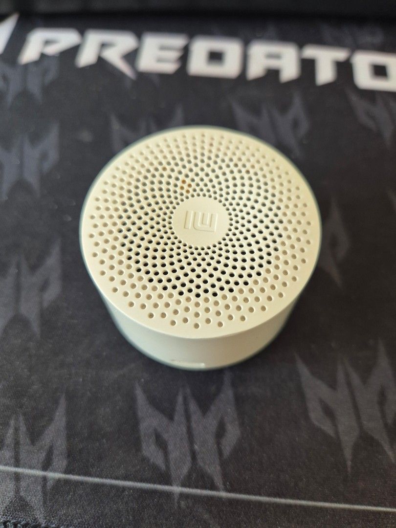 Xiaomi Mi Compact Bluetooth Speaker 2 (Category: Soundbars, Speakers & Amplifiers) located in Makati City. Submitted by zotag (Listing ID 1439251238, Image 1). Description: - Xiaomi Mi Compact Bluetooth Speaker 2 - Compact and portable design - Micro-USB charging - Features a power button and LED indicator - White color - Circular design with sound output holes.