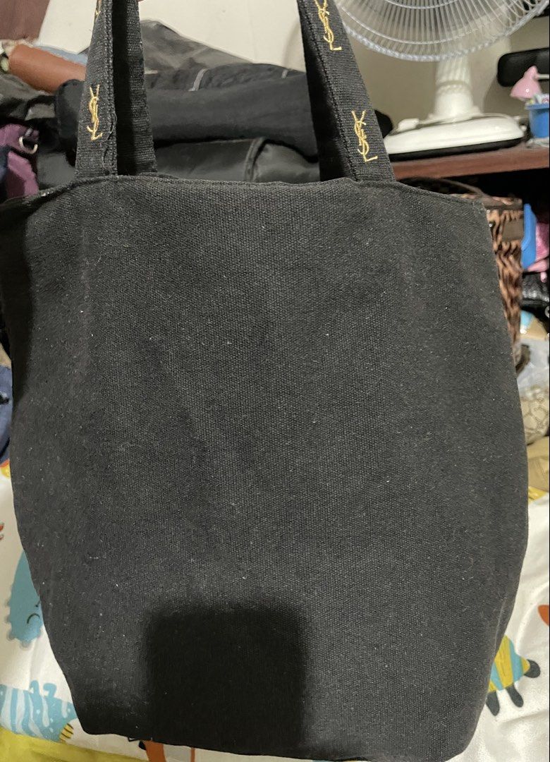 YSL Black Tote Bag (Category: Luxury Bags & Wallets) located in Manila. Submitted by goldenphoenix_ac6904 (Listing ID 1439403132, Image 2). Description: - YSL black tote bag - Gold embroidered logo on front and handles - Pink fabric interior lining - Includes small pocket with YSL logo - Simple, classic design - Ideal for everyday use.