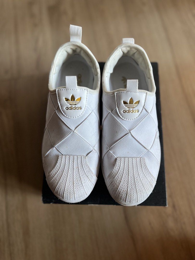 Adidas Superstar Slip-On White Womens (Category: Sneakers) located in Pasig City. Submitted by grndhub (Listing ID 1439528098, Image 2). Description: - Original Adidas Superstar slip-on womens - White - Classic shell toe - Woven upper - Size: US 6, UK 4.5, EUR 37 1/3 - No box - Just needs cleaning Pick up Pasig.