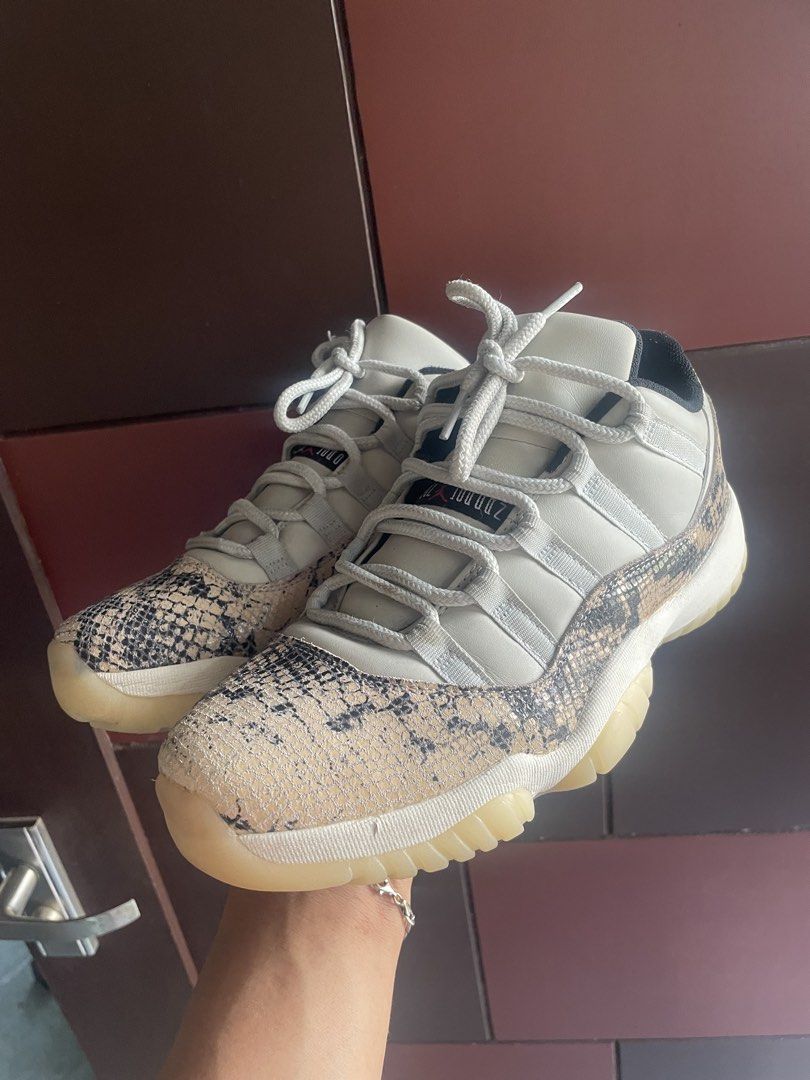 Air Jordan 11 Low Snakeskin (Category: Sneakers) located in Laguindingan. Submitted by kixseven (Listing ID 1439442606, Image 3). Description: Air Jordan 11 Low sneakers with snakeskin detailing. Features a white upper with snakeskin on the toe and heel. The soles are translucent with a red Jumpman logo. The shoes have white laces and a black inner lining. The Jumpman logo is visible on the heel. - No COD ❌ - Location : Mindanao - Ship nationwide